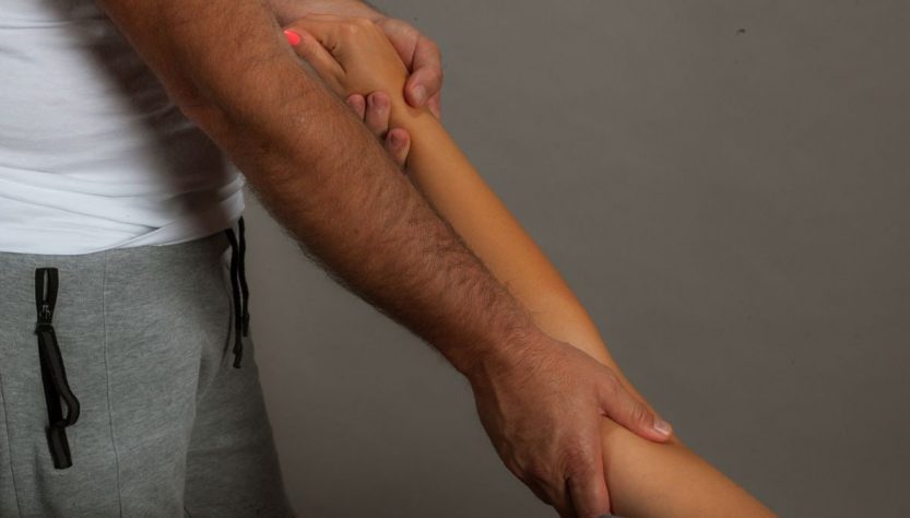 Close-up of therapist performing a soothing arm massage promoting relaxation and well-being.